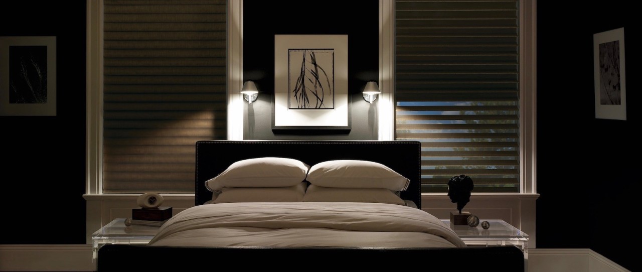 Dark bedroom with bed and light dimming shades